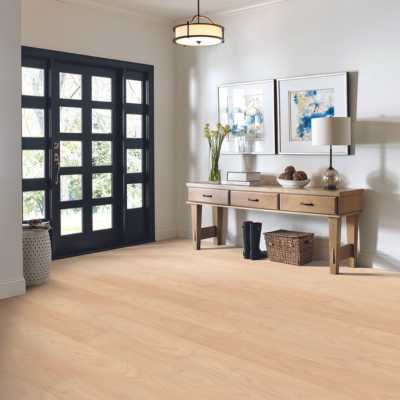white oak look luxury vinyl in entryway of modern home with artwork and entryway table
