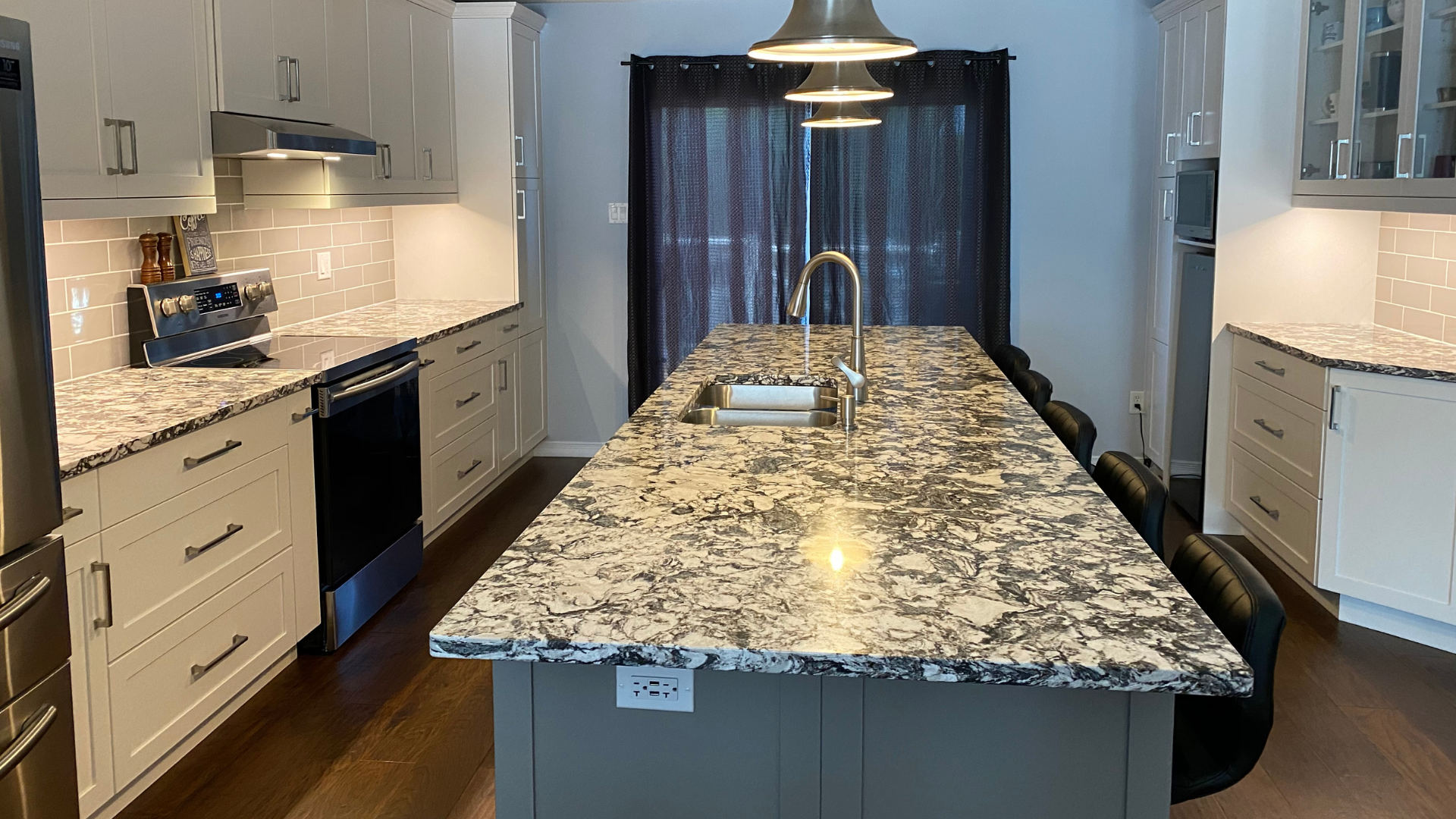 stone countertop in new design kitchen with white cabinets and gray island cabinets